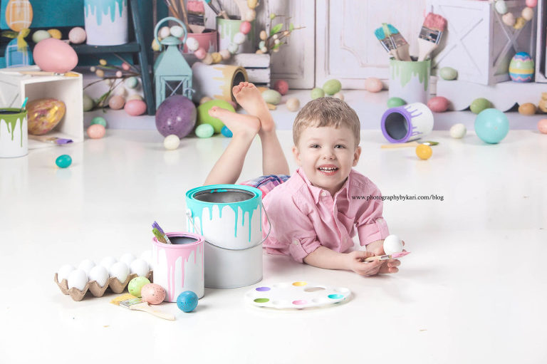 Easter portrait of boy in a pink shirt with paint buckets