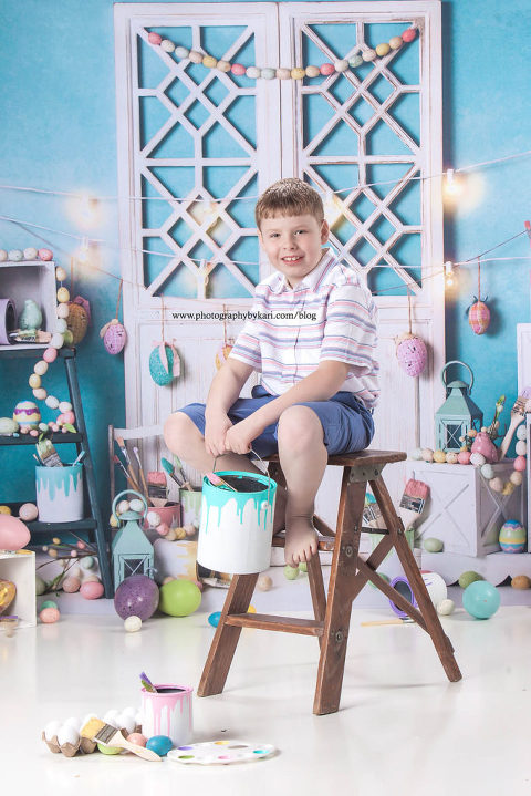 Easter portrait of boy holding a paint bucket