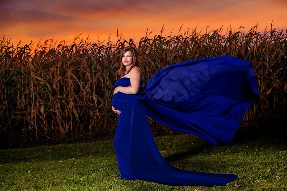 SE MN Maternity blue gown portrait in front of corn field and sunset