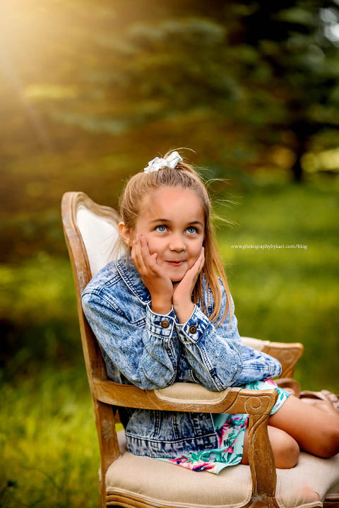 Little girl sitting in chair rolling eyes