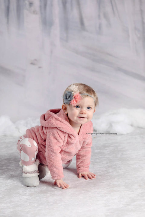 baby kneeling on snow