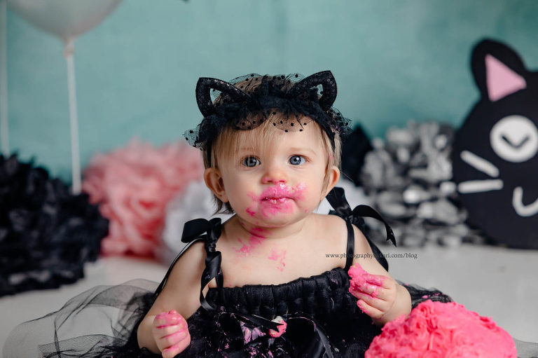 baby with pink frosting on face