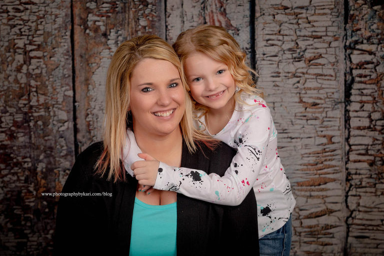 Daughter with arms around mother portrait
