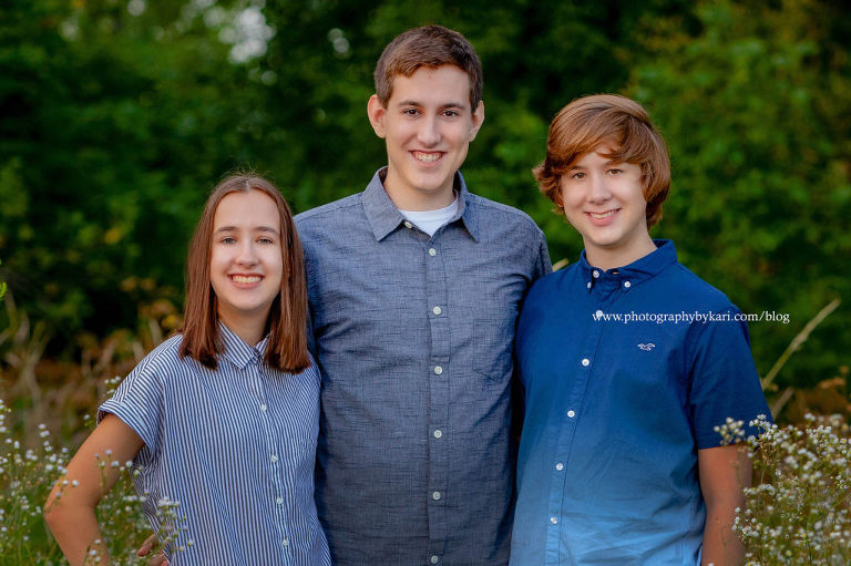 Triplet Sibling outdoors on blue shirts
