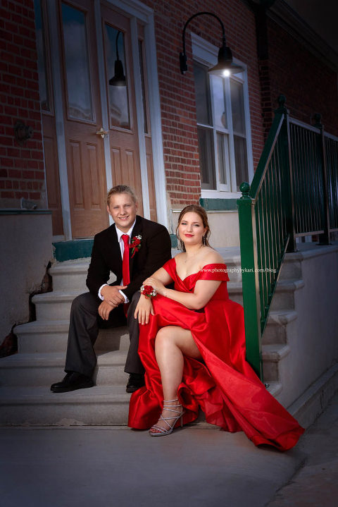 prom couple sitting on steps in spring valley, MN