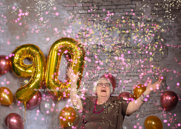 90 year celebrating birthday throwing confetti