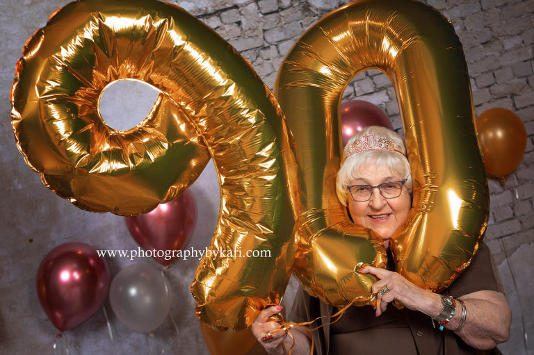 90 year old woman Ellen McGill with head in 90 balloons