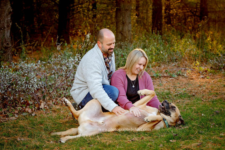 couple playing with dog portrait at quarry hill taken by photography by kari