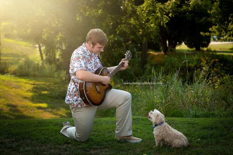 Senior guy portrait with dog and guitar
