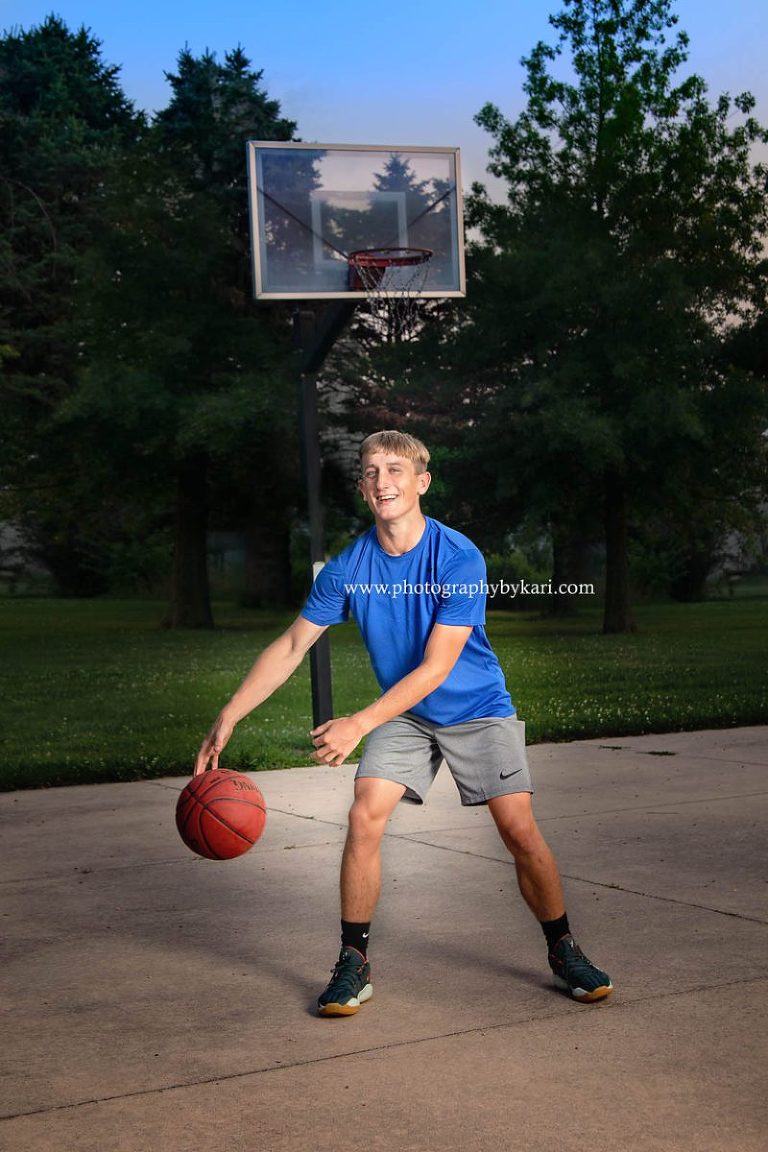 SE MN Senior boy with Basketball in front of hoop