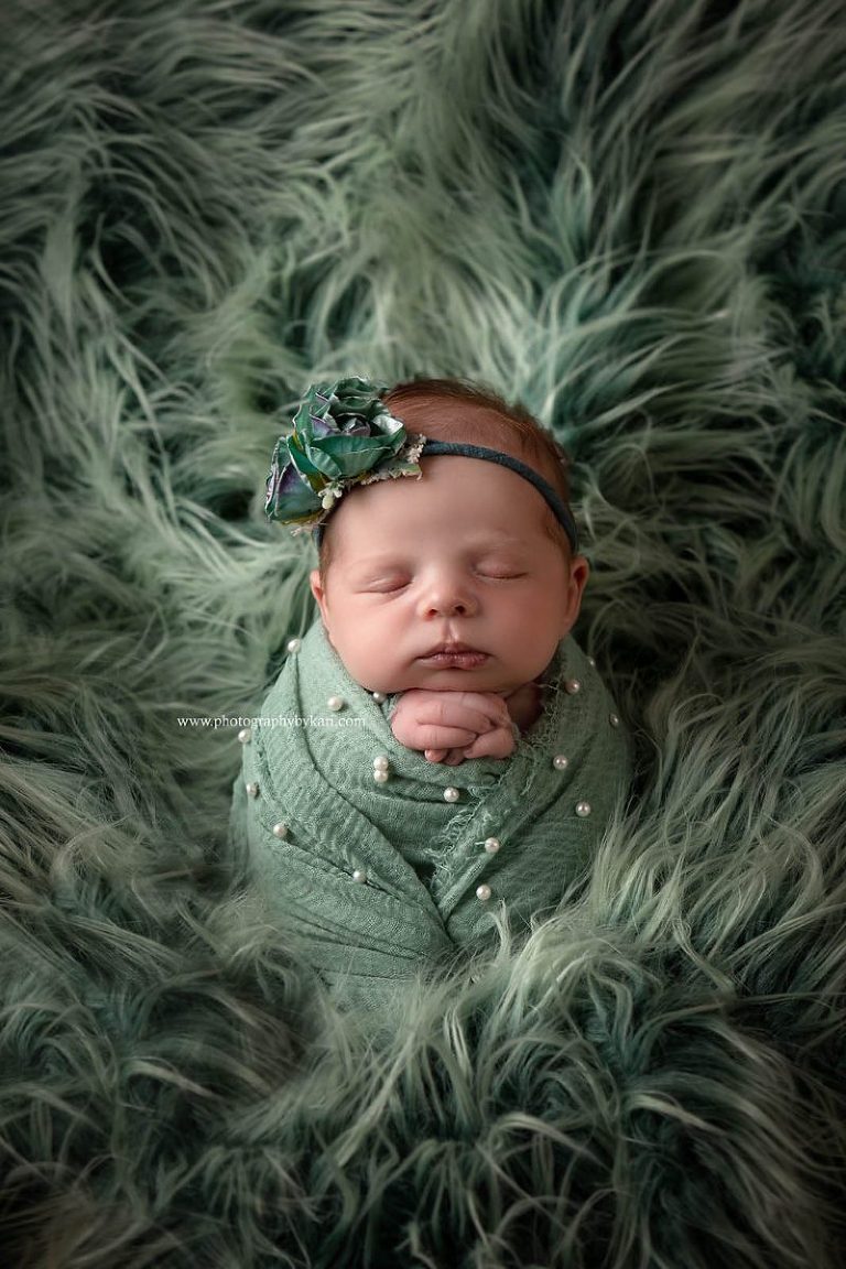 MN Newborn girl portrait in green wrap