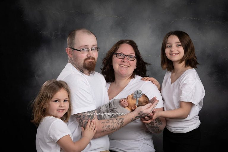 Newborn girl portrait with family