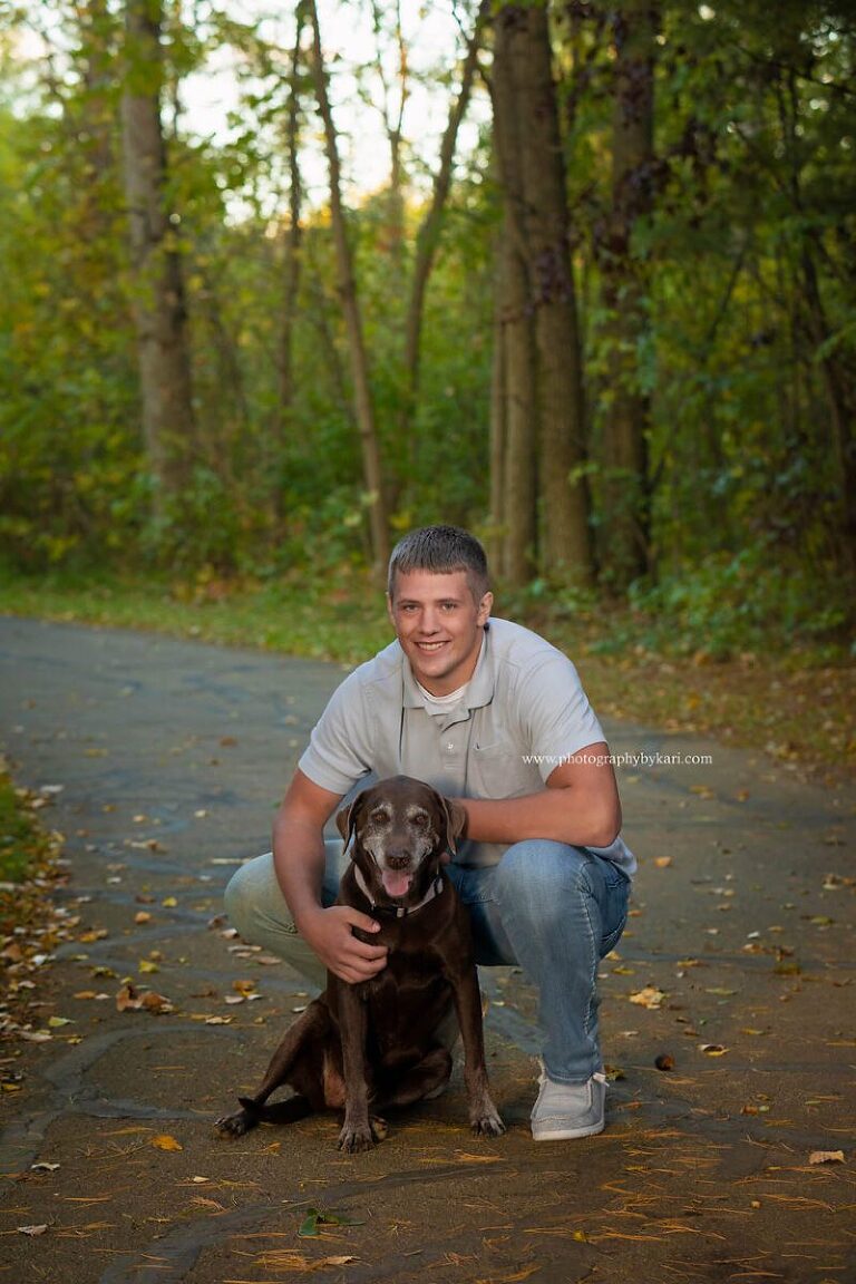 Mason poses with his dog for his MN senior pictures.