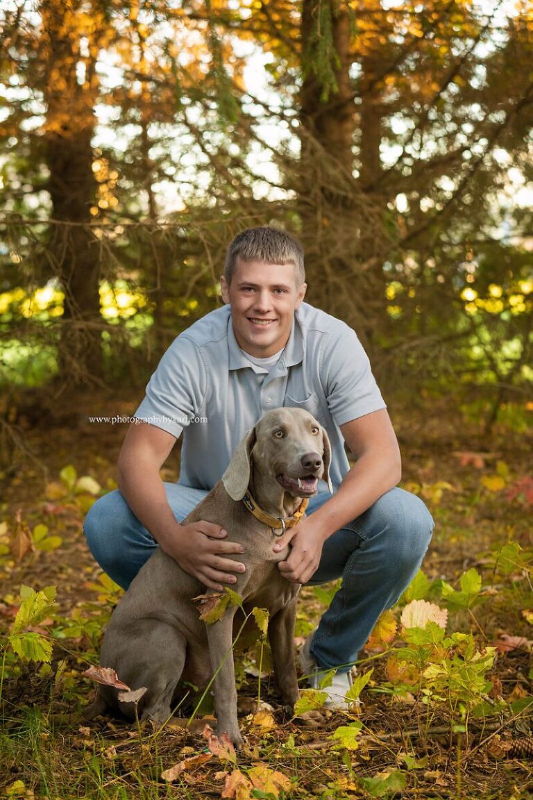 Mason poses with his dog for his MN senior pictures.