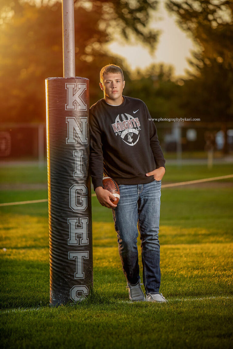 Mason poses casually at the Kingsland Football field for his SE MN senior pictures.