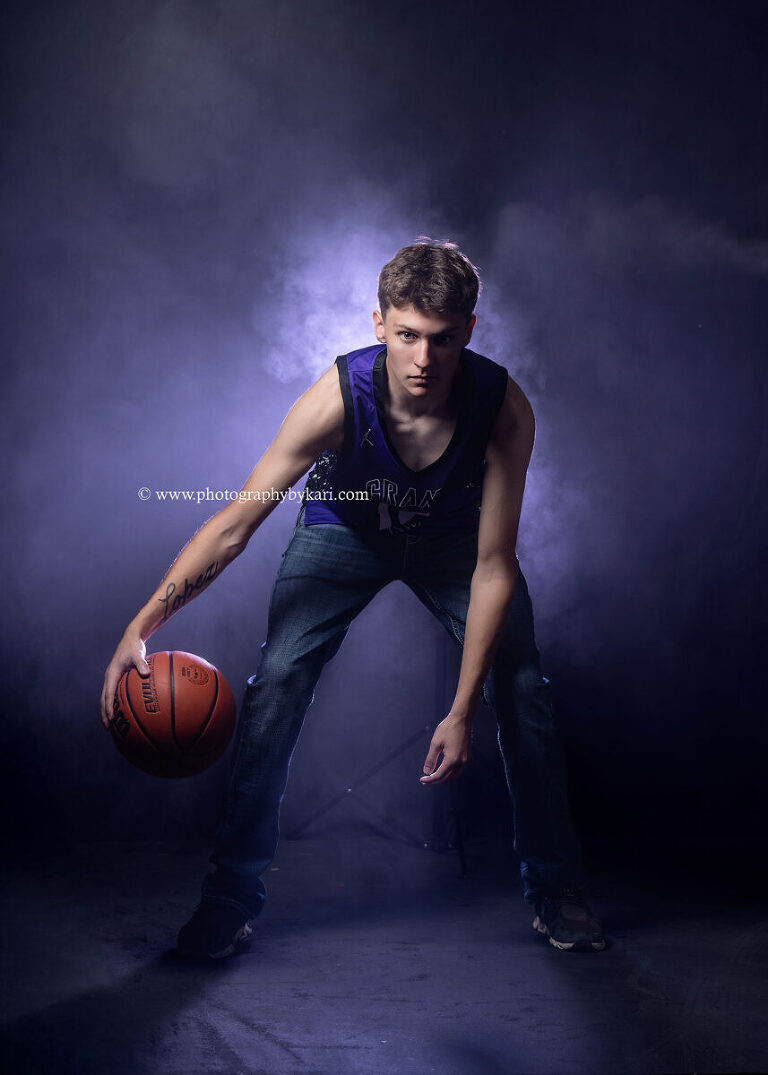 Grand Meadow High School senior athlete in dramatic basketball photo