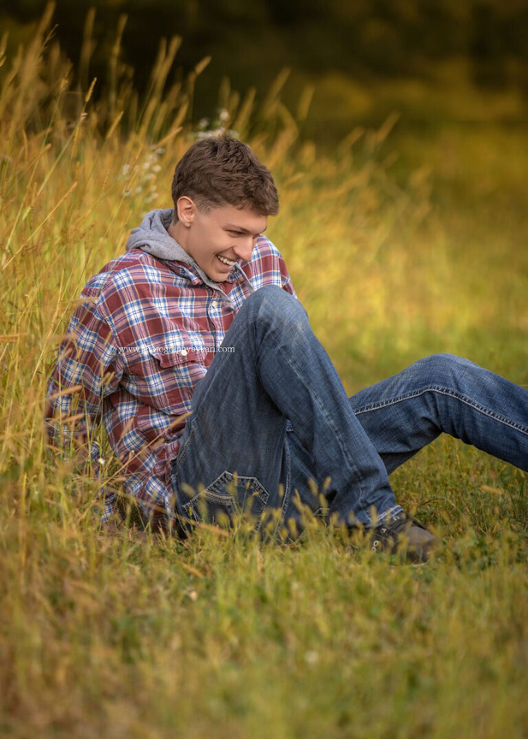Senior boy laughing after taking a tumble during photo shoot