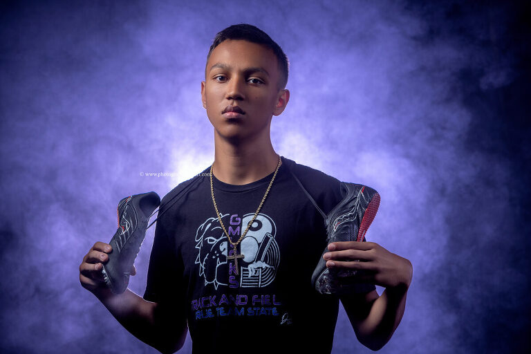 Track and field senior photo with creative lighting effects