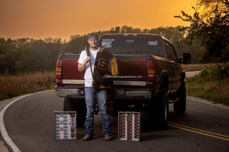Senior boy with trap shooting gun and awards