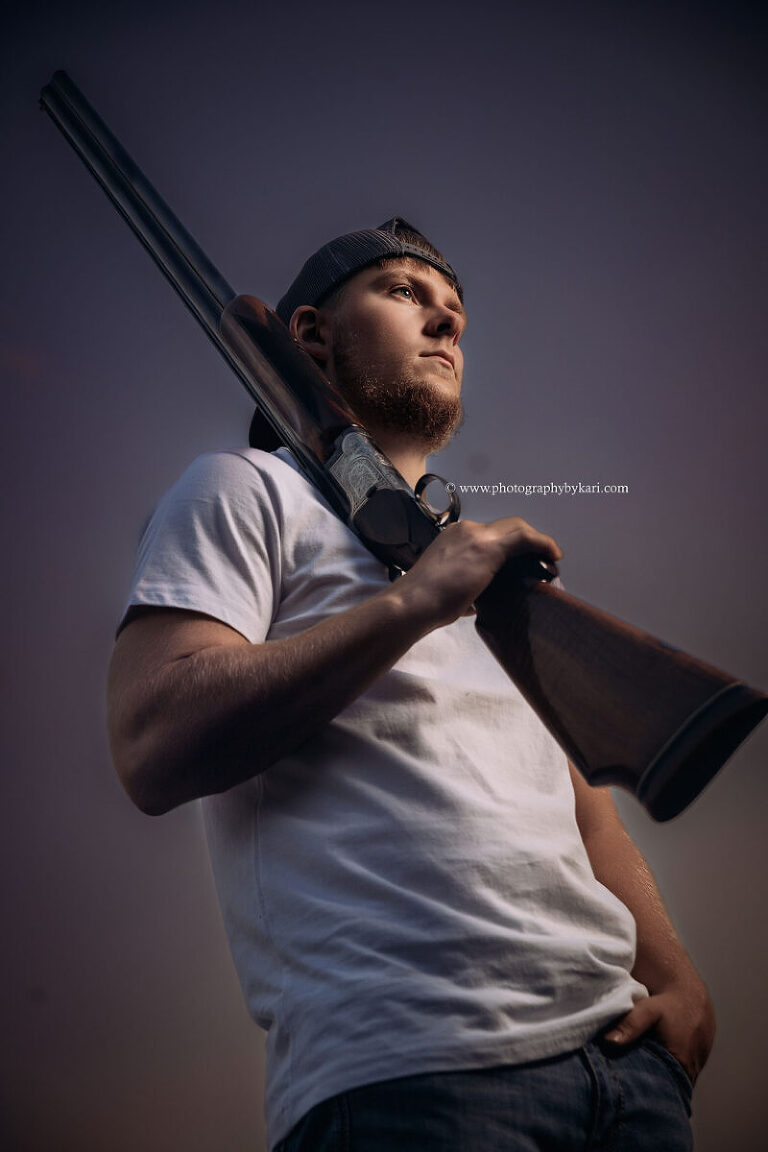 High school senior posing with grandfather’s gun