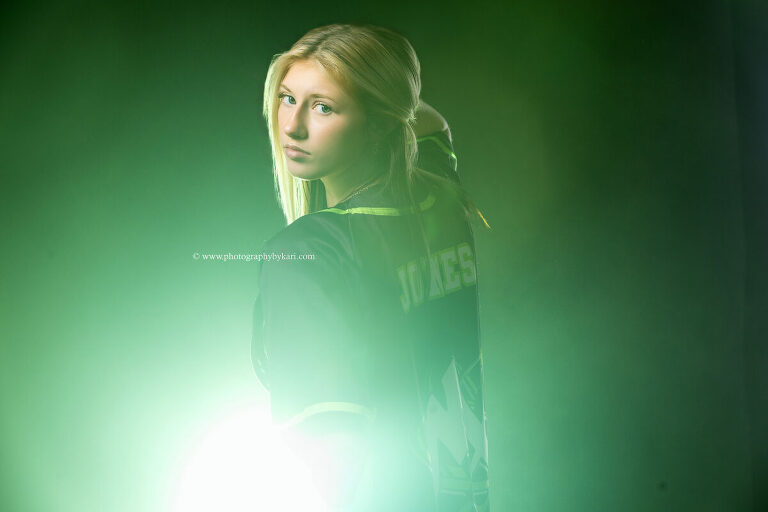 All-star cheer senior photo with smoke and colored gel lighting