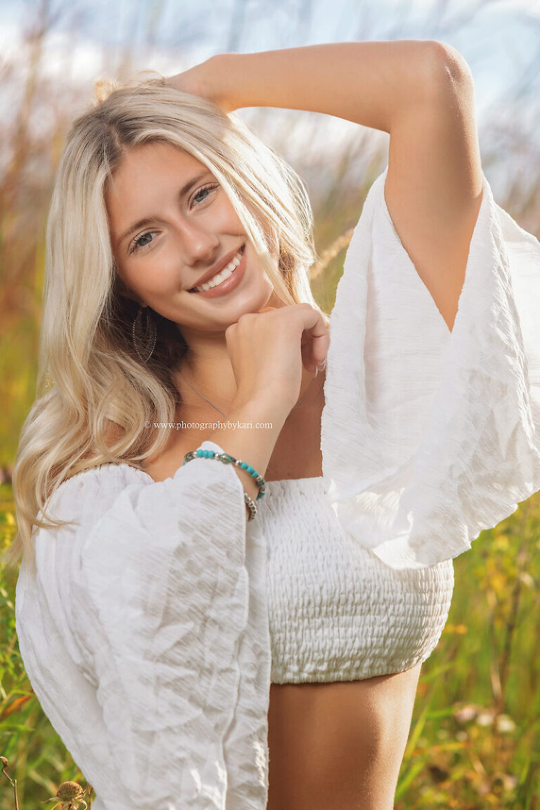 Cassie surrounded by wildflowers and tall grass