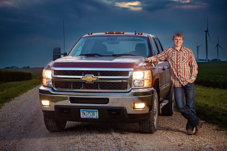 Seth posing on gravel road in rural Spring Valley, MN with his truck  during HIS SE MN senior photo session