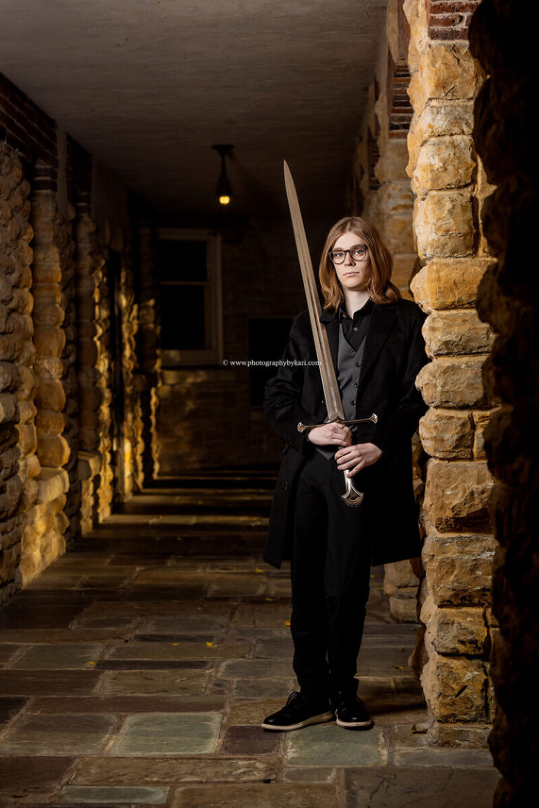 Sword-themed senior photo taken at Plummer House in Rochester M