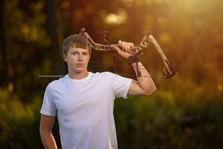 Senior portrait with bow on country property in Southeast Minnesota