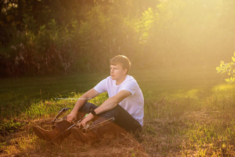 Senior portrait with bow on country property in Southeast Minnesota