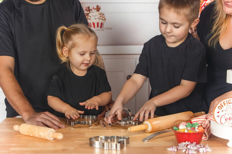Big brother and big sister baking cookies during Christmas mini session in SEMN