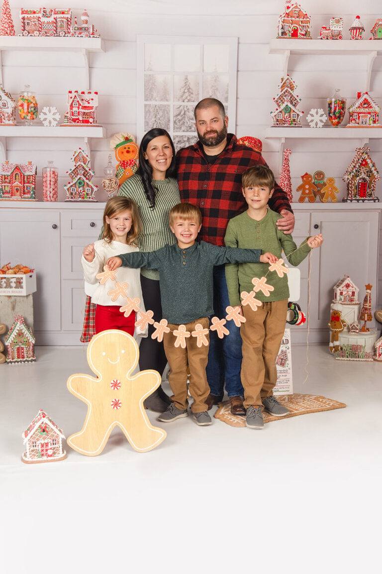 Family baking gingerbread cookies during Christmas mini session in Spring Valley MN