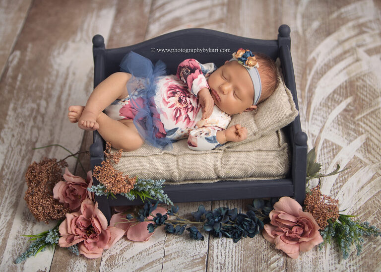 Newborn portrait of baby girl with soft bed and gentle lighting Rochester Minnesota area