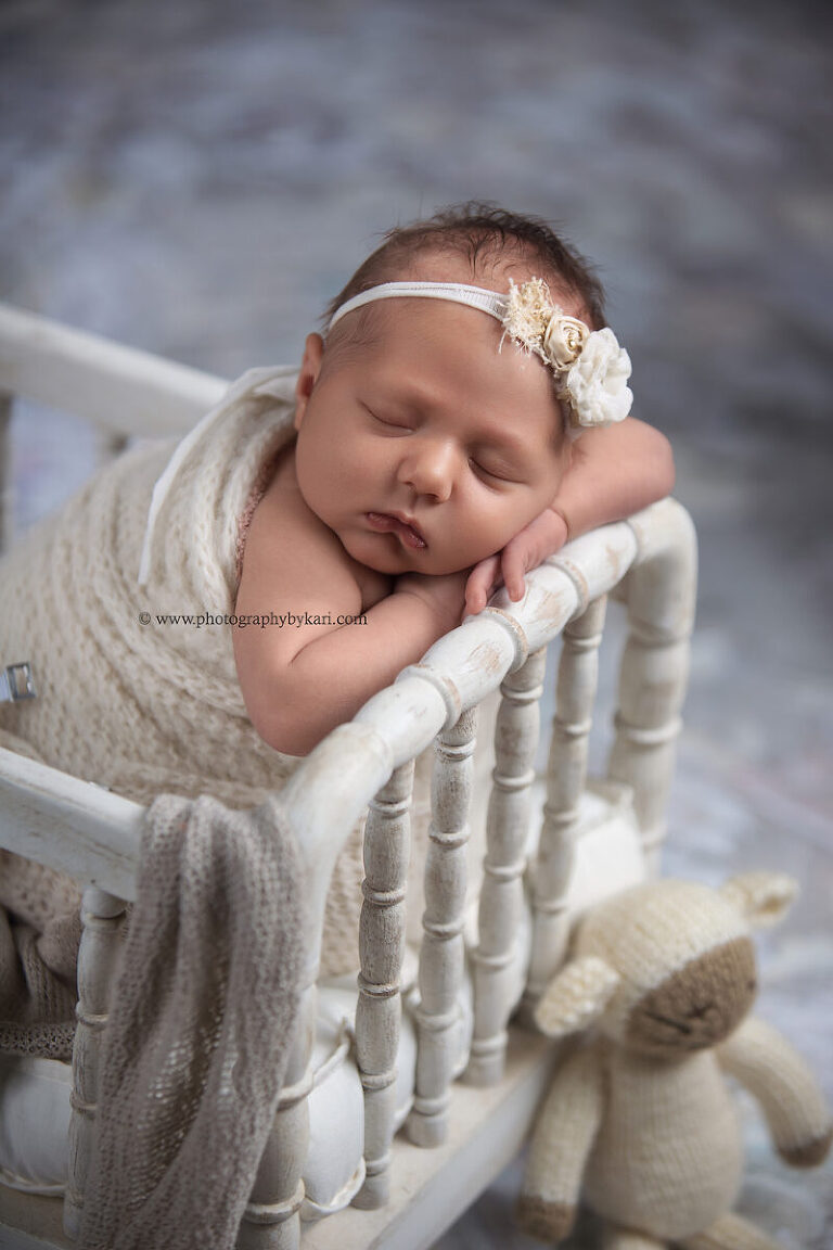 Newborn photography session featuring baby girl in soft wraps and textures Minnesota photographer