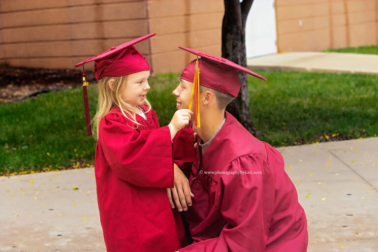Class of 2026 graduate with younger sister at Stewartville High School