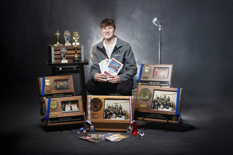 Southland High School Class of 2026 senior photo with one act play trophies