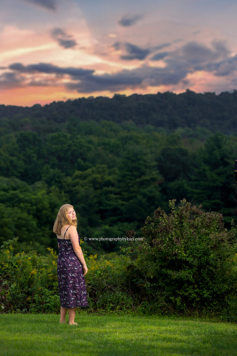 Senior girl walking through fall colors at Good Earth Village