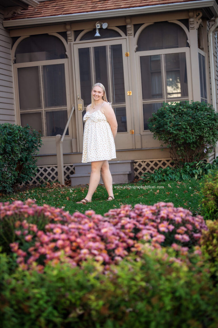 Senior girl posing near flowers during downtown Rochester session