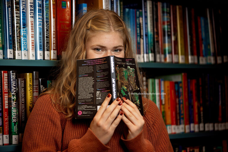 Senior girl reading books at Stewartville Public Library