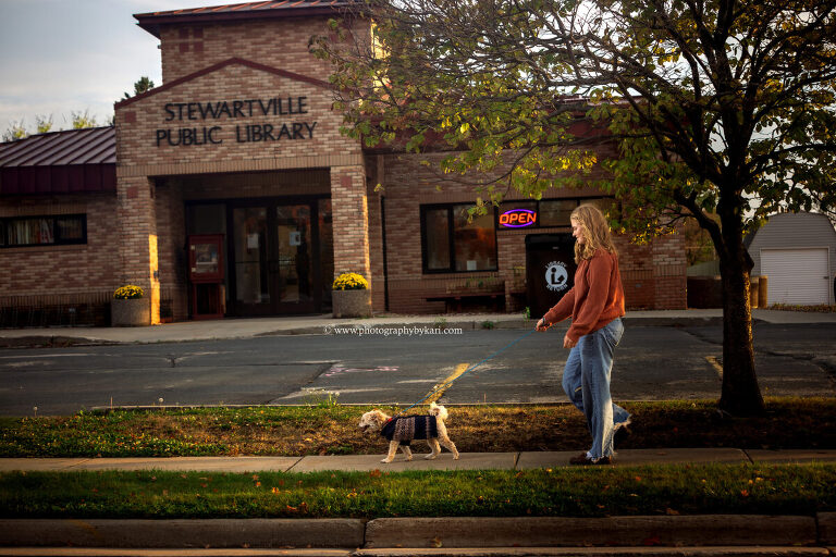 Senior girl with her dog outside Stewartville Public Library