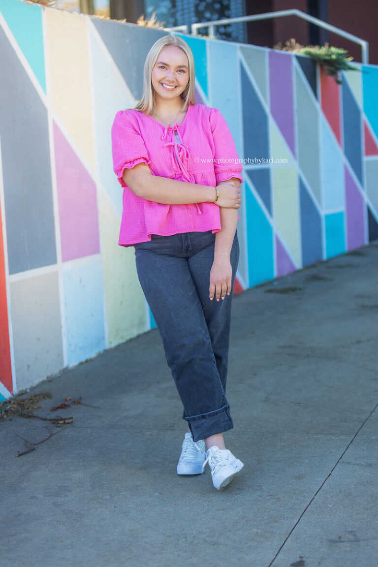 Urban senior portrait featuring downtown Rochester architecture