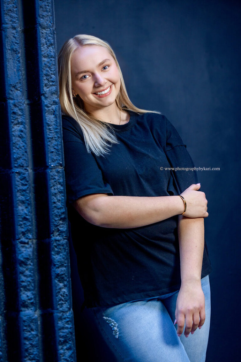 Urban senior portrait featuring downtown Rochester architecture