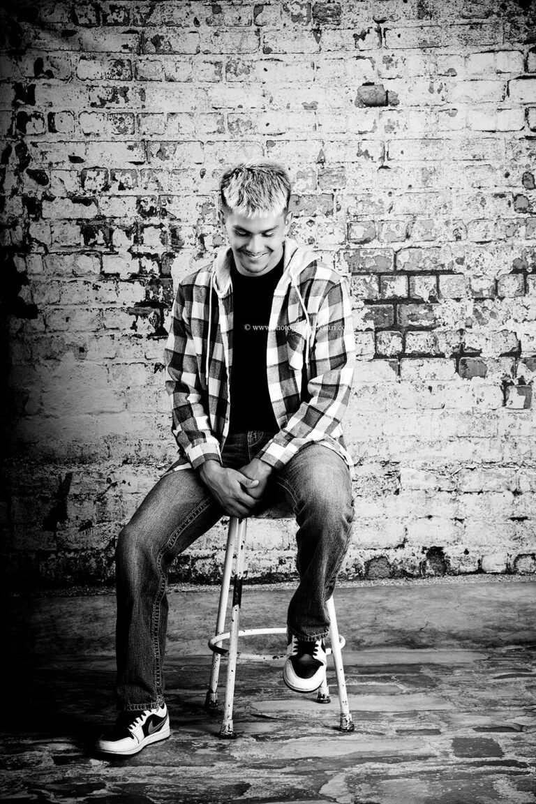 Black-and-white senior portrait of Nathaniel in the Photography by Kari studio
