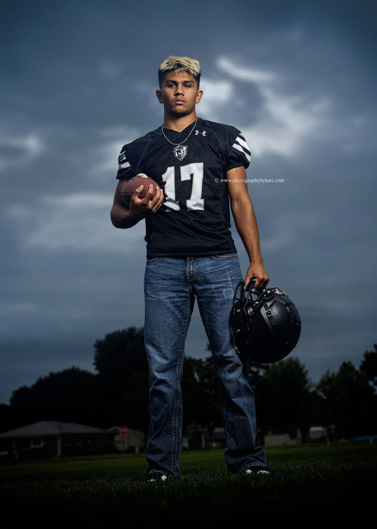 Nathaniel in his football uniform at the Kingsland football field during his senior pictures